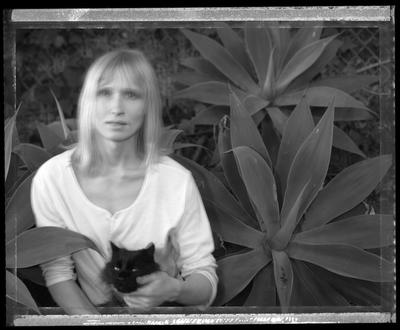 Kathleen Malan/Thompson, with Nervil the cat. Artist, LA, 1989